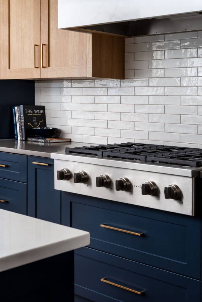 Ridgeview Renewal House kitchen in Tuscany, Calgary, with large square island, by Rusch Design Build